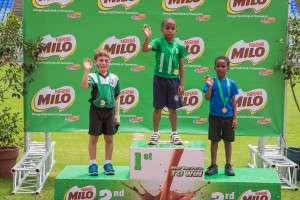 Photo 8 - Waving with pride – youngsters collect their medals atop the podium